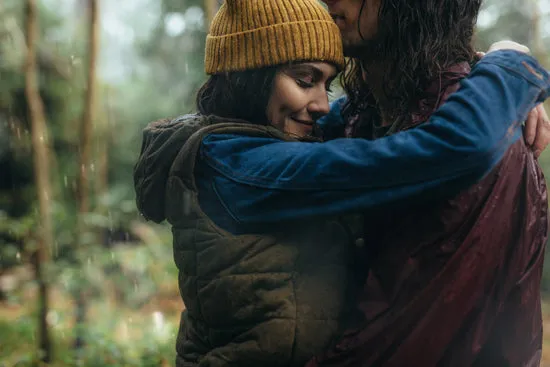 Couple sharing romantic moments under the rain